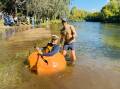 In an 'oh my gourd' kind of moment, Captain Adam Farquharson takes to the Tumut River in his boat - a giant pumpkin grown by Tumut's Mark Peacock - on Saturday. Picture supplied 