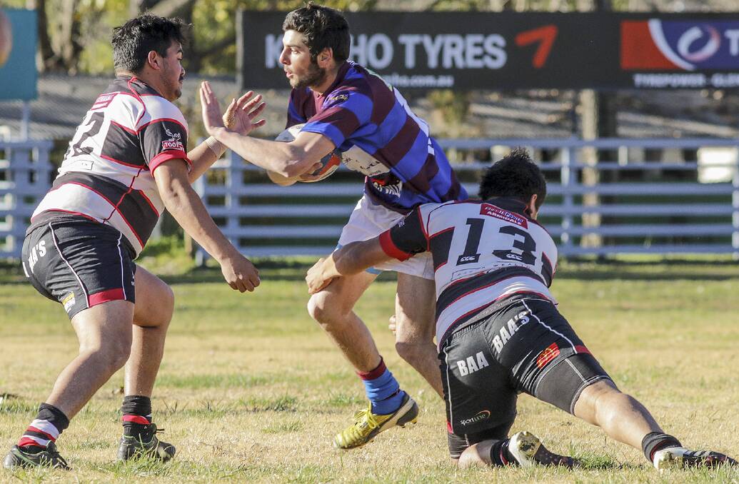 BATTLE THROUGH: Michael Miller is brought to ground by Barbarians' defenders in Saturday's narrow loss at Glen Innes showground. The GhostStags have the bye before they face Robb in the final round. Photo: Tony Grant