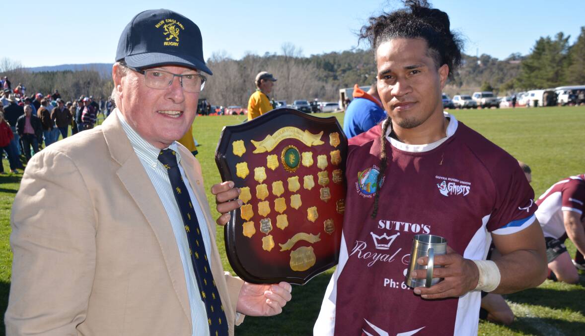 STILL A WINNER: New England rugby union president David Clifton presents Liva Sili with second grade's best and fairest award. The Ghosts were defeated in the grand final by Albies 16-7. 