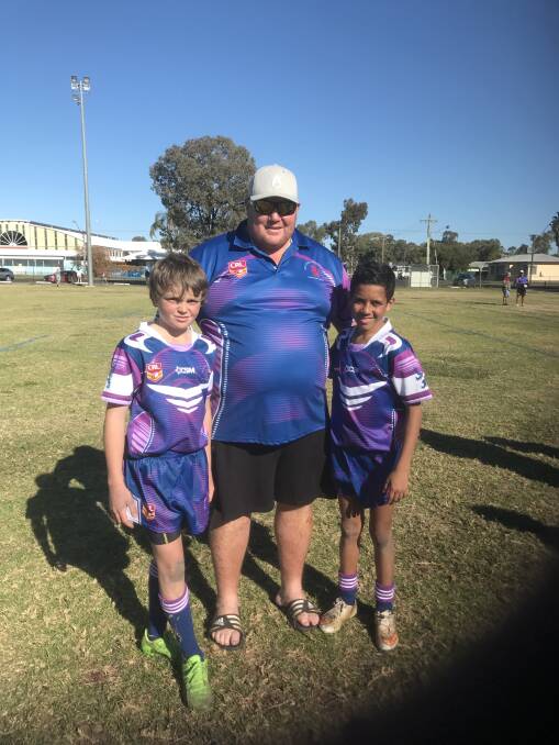 BIG FUTURES: Tom Lockyer and Tahmani Landsborough with Group 19 under 12s coach Peter Presnell. 