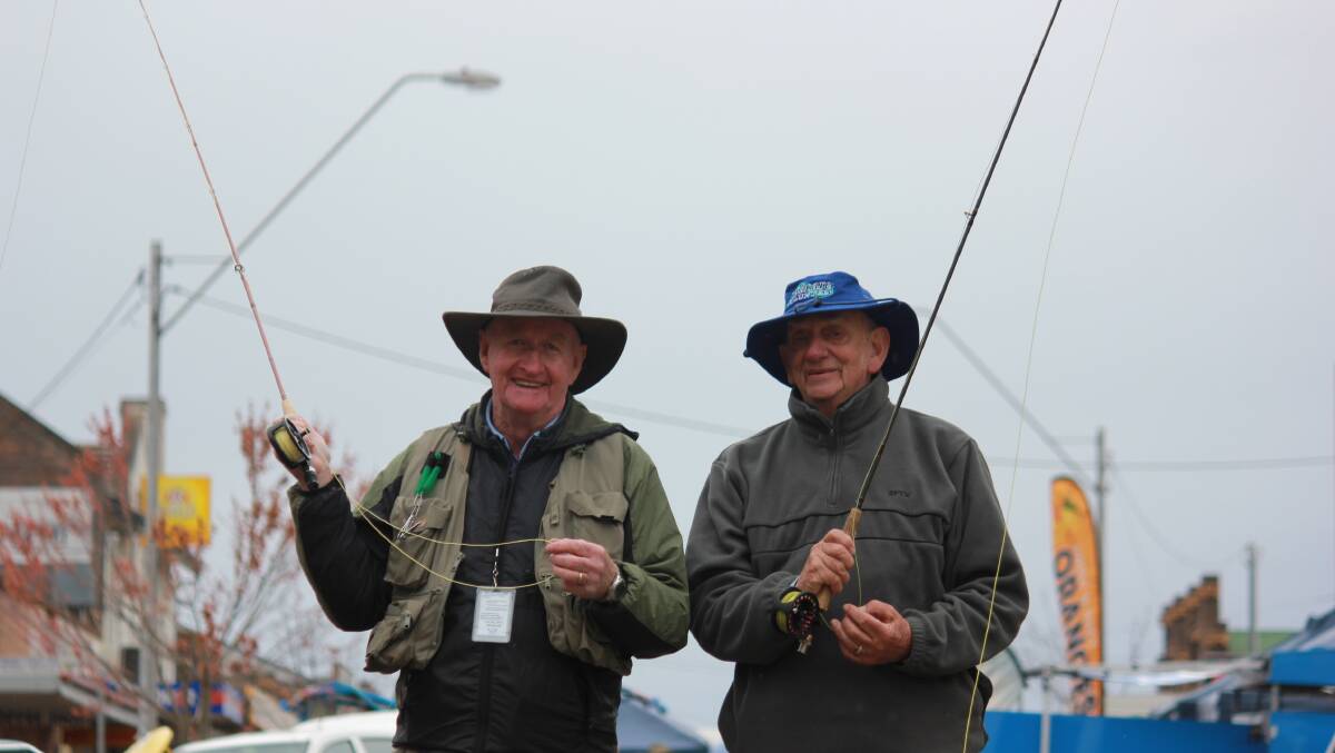 GONE FISHING: Fly fishermen Laurie Muldoon and Alan Brodbeck taught crowds the precise art of fly-fishing in Bradley Street at the Guyra Trout Fest on Saturday.