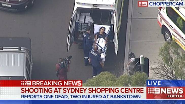 A victim is loaded into an ambulance after a shooting at Bankstown Central Shopping Centre. Photo: Channel Nine