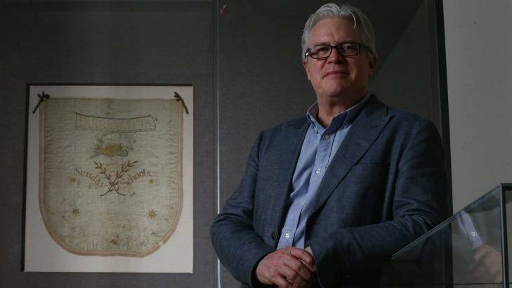 Curator Nat Williams with the Parramatta Sunday Schools 1815 banner at the National Library of Australia. Photo: Alex Ellinghausen