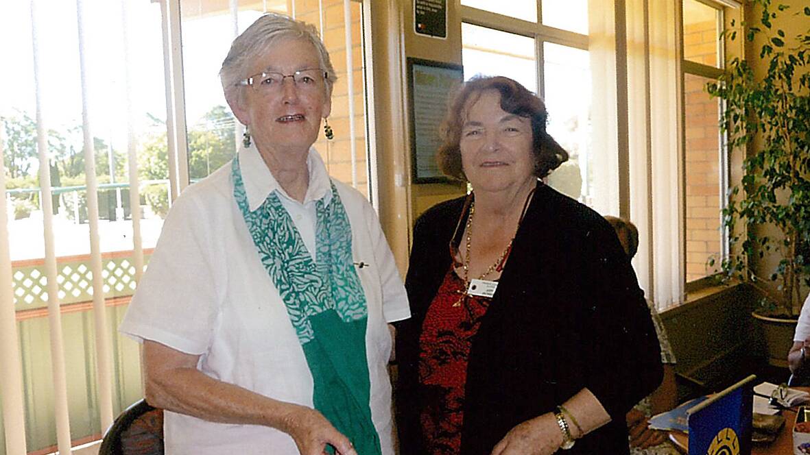 Judy Jackson (right) handing over to new Secretary Margaret Grills
