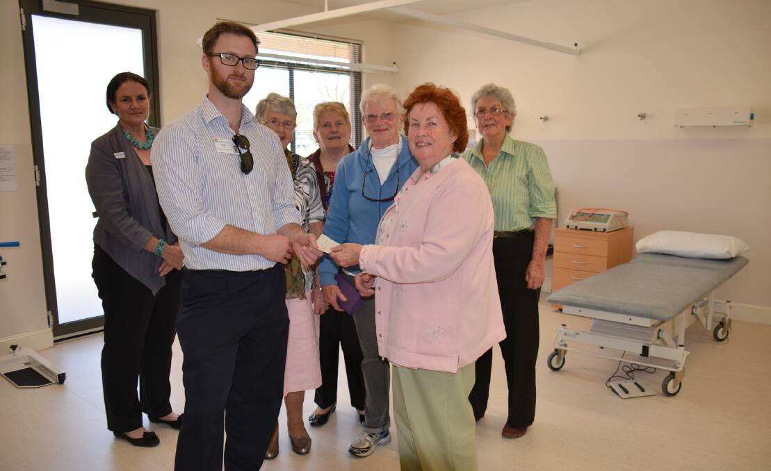 Guyra  MPS Acting Health Service Manager Wade Smith accepts a cheque from Trish Field
watching on are  Tablelands Cluster General Manager Wendy Mulligan and auxiliary members 
Nancy Davidson, Wilma Reeves, Marg Vidler and Gwen Williams