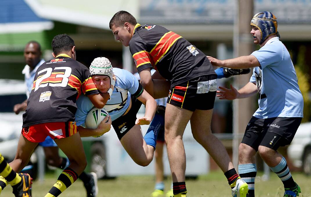 Scott Miller is tackled against the Boomerangs while Jared Layland 
moves in to help out at the recent Armidale nines competition