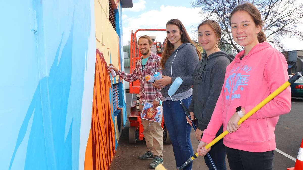 PAINT THE TOWN RED: Guyra Central School students were on hand to help transform the drab shed in Cinders Lane.