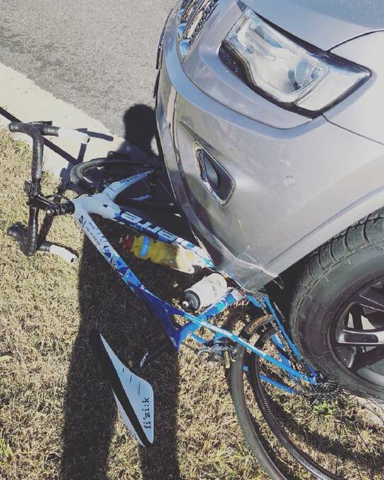 Crash scene: The bike under the car on Bundarra Road at Armidale on Sunday afternoon. Photo: Supplied