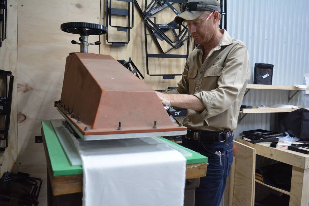 Luke Sutton has worked out how to use Drifta's unique material cutting machine to cut down the time it takes to shape the mask cotton. Photo Anne Keen 