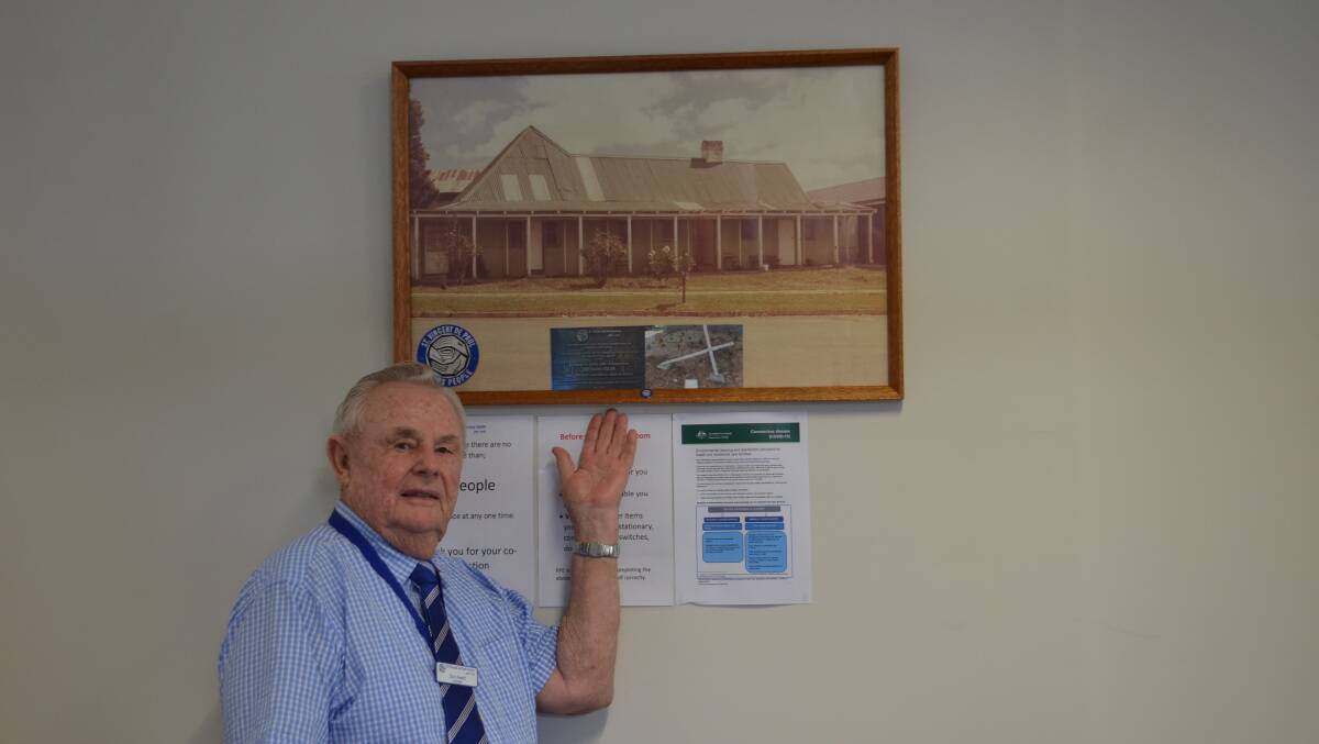 Mr Hewitt with a picture of the original Crescent Guesthouse which he bought for the St Vincent de Paul Society in 1978 for $25,000. 