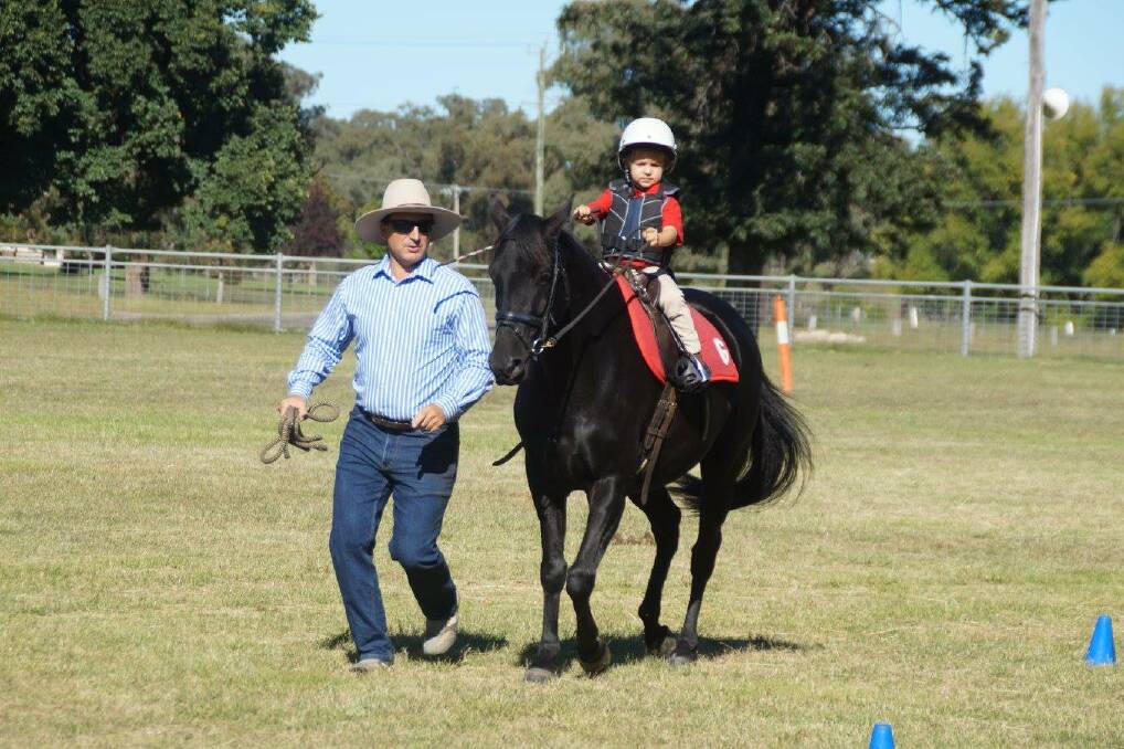 HITTING HIS STRIDE: Austin Kelly, accompanied by dad Rob, trots along at the Bundarra Pony Club mini-camp. Guyra's youngsters travelled to the event last week. 