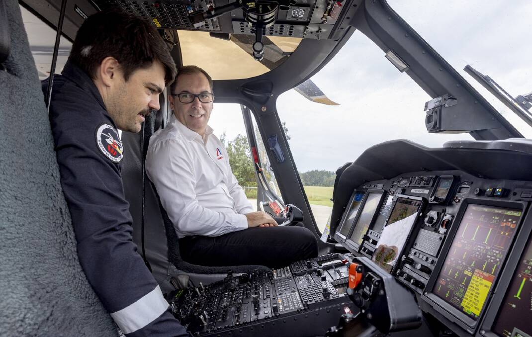 Westpac Rescue Helicopter Service Aircrew Officer Matt Dippolito gives Ampol General Manager Business to Business Brad Phillips a run through of the controls on board the Services state of the art AW139 helicopter.