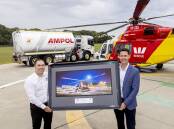 Westpac Rescue Helicopter Service Acting CEO James Lawrence, with Ampol General Manager Business to Business Brad Phillips, at the Services Belmont base for the official contract signing, with the backdrop one of the Services AW139 aircraft and a Westpac Rescue Helicopter Service branded Ampol fuel truck.