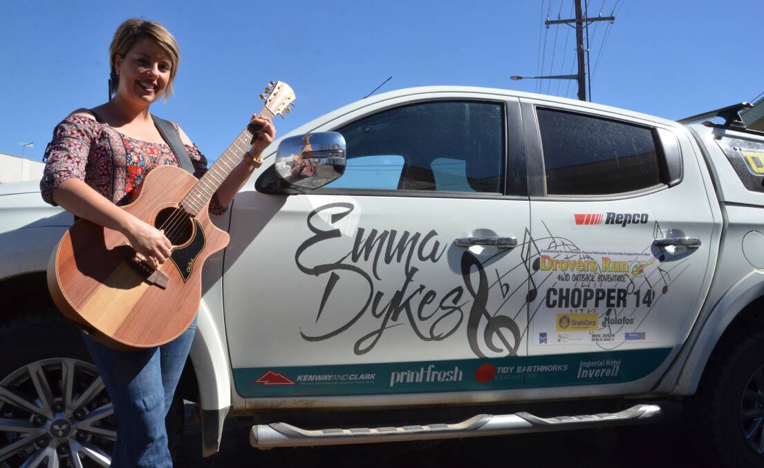 Dusty: Emma Dykes with the car she drove through outback Australia for the rescue chopper.