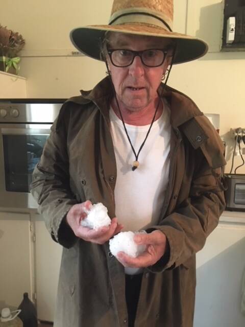 WILD WEATHER: Boorolong resident Mark Kearney holds hail the size of cricket balls that fell at his property on Christmas Day. The hail damaged parts of his home including windows and pipes and littered his yard.
