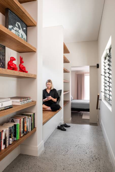 The passage between the living area and the master bedrooms acts as a tiny library. Photo: Dion Robeson