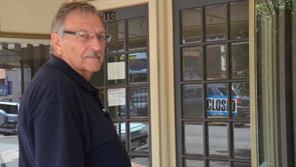 CLOSED: Guyra & District Chamber of Commerce president Hans Hietbrink examines an empty shopfront. Photo: Nicholas Fuller