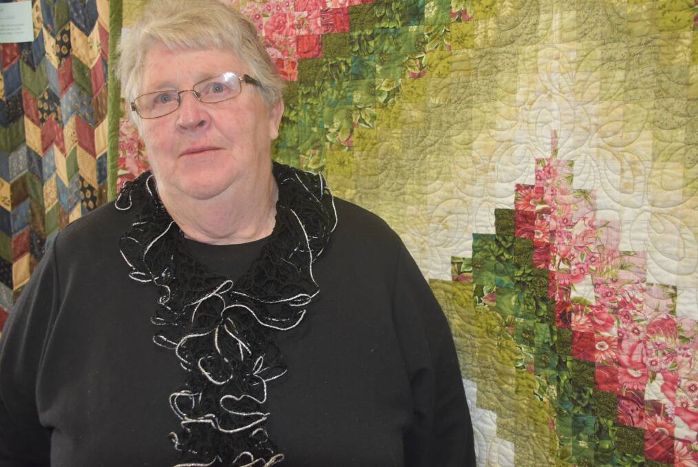 QUILTER: Glenda Soraghan standing next to one of her quilts. Photo: Nicholas Fuller
