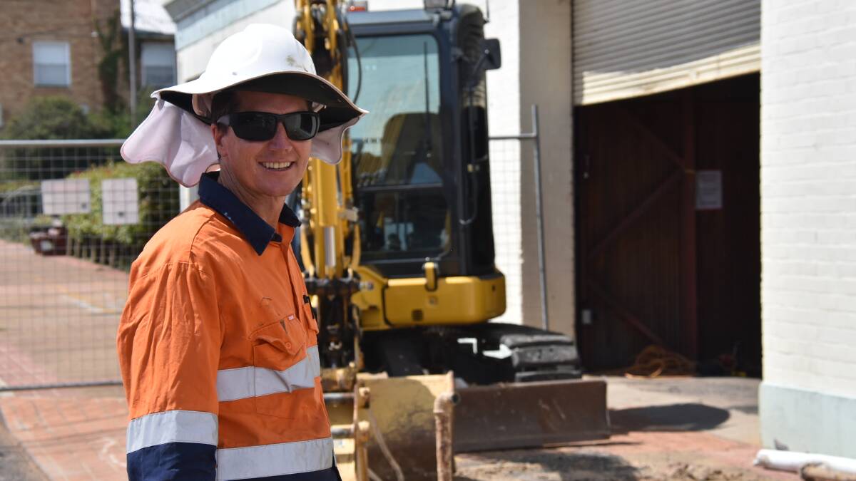 IS THERE A DOCTOR IN THE STREET?: Environmental engineer James Morrow, from the Ground Doctor, is removing tanks in Guyra's Bradley Street. Photo: Nicholas Fuller