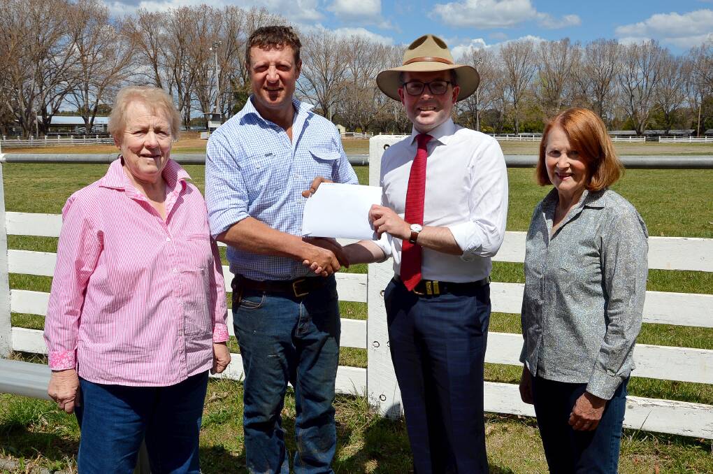 SHOWTIME!: Northern Tablelands MP Adam Marshall presents Guyra Show Society President Richard Post with a $5,000 cheque for next year’s show. They are flanked by Show Society Secretary Dorothy Lockyer, left, and Vice President Rita Williams, right. Photo: Supplied