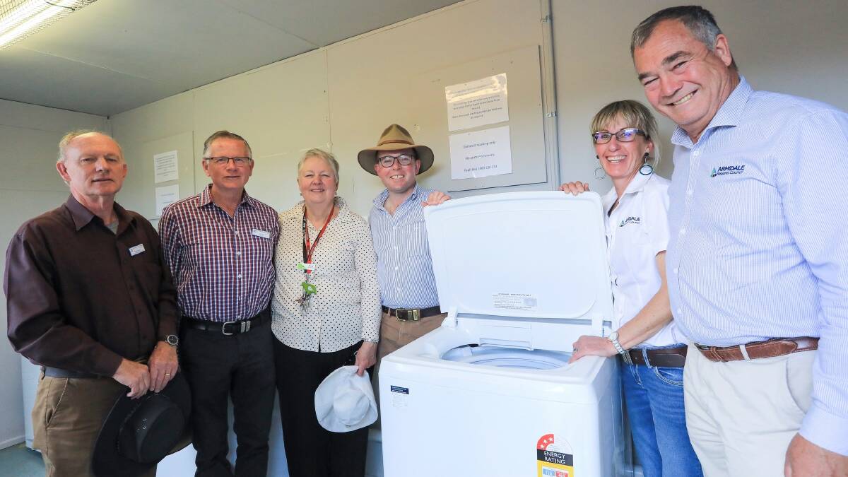 St Vincent de Paul Society volunteers Paul Burton and David Kanaley with The Hub at Guyra Centre Co-ordinator Chris Hietbrink, Northern Tablelands MP Adam Marshall, Armidale Regional Council Deputy Mayor Libby Martin, and Mayor Simon Murray in the new free community laundry at the Guyra Showground.