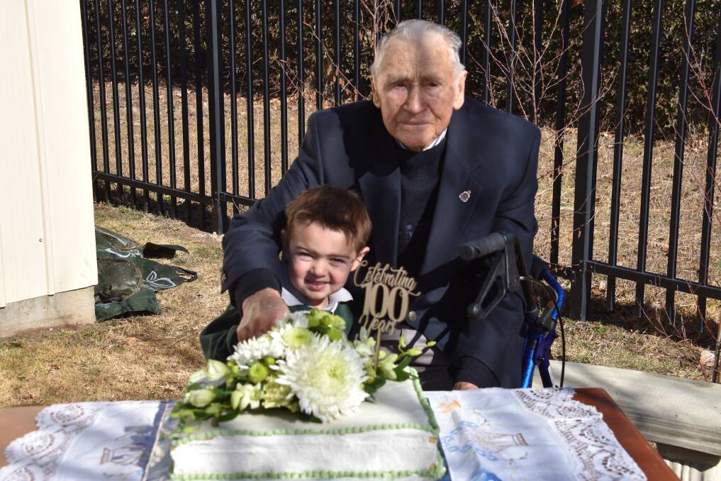 OLDEST AND YOUNGEST: 102-year-old ex-pupil Ted Mulligan and Chase Martin cut St Mary's 100th birthday cake. Photo: Nicholas Fuller