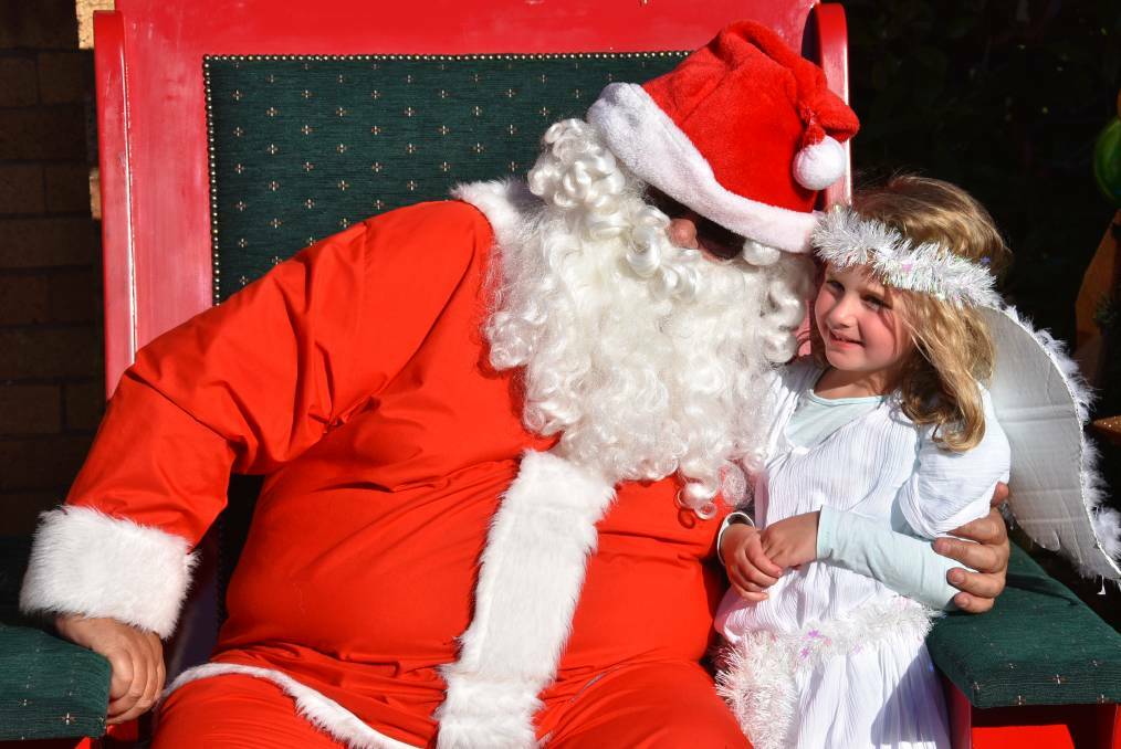 Santa Claus and a little angel at last year's community Christmas party. Picture - Nicholas Fuller.