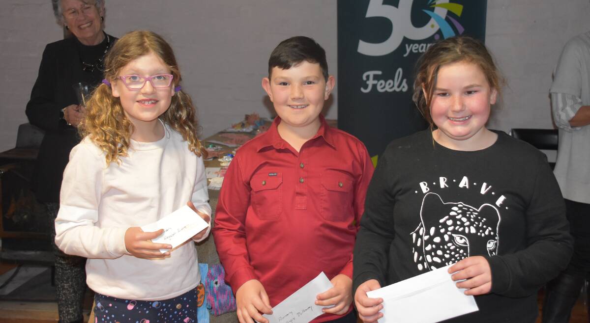SMILES: Eleizabeth Evers, Angus Dulloway, and Kiearnna Wadley, prize winners in the Primary School section. Photo: Nicholas Fuller