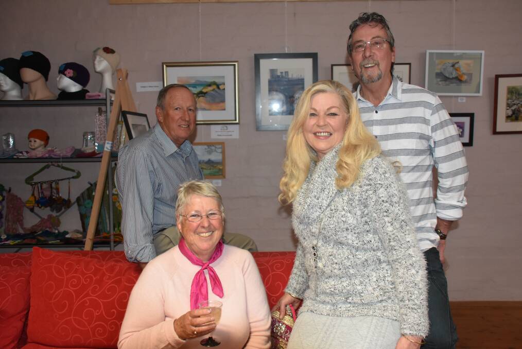 SMILES: TroutFest co-ordinator Lynne Chapman and husband Wal, Caffiends owners June and Neil Paine. Photo: Nicholas Fuller