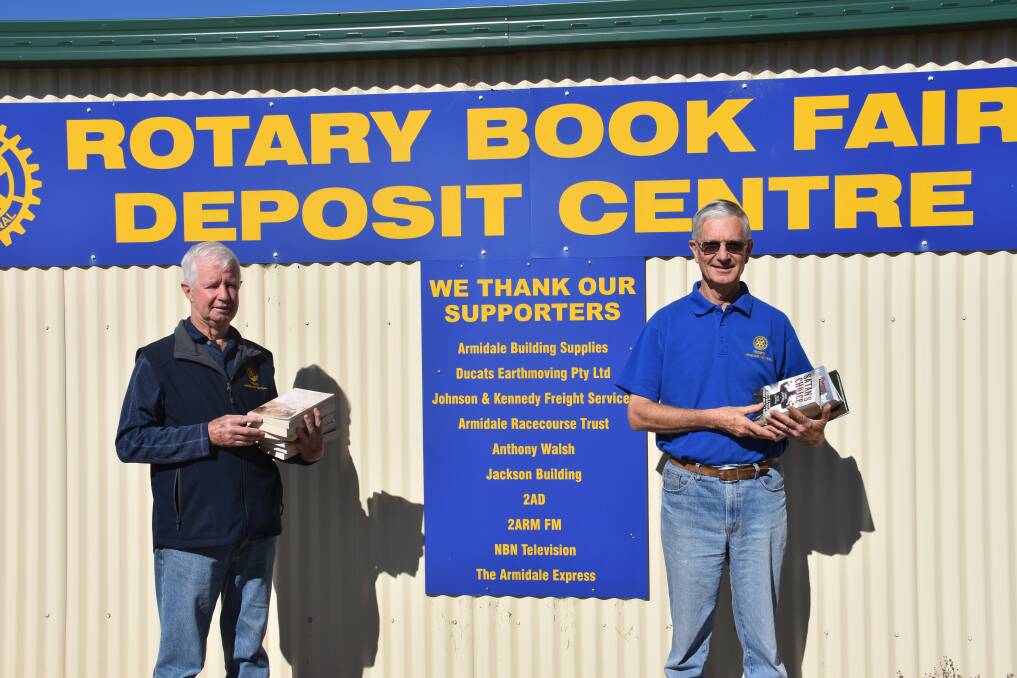 BOOKLOVERS: Rotary's Ian Garske and Simon McMillan with just some of the thousands of books for sale this year. Photo: Nicholas Fuller