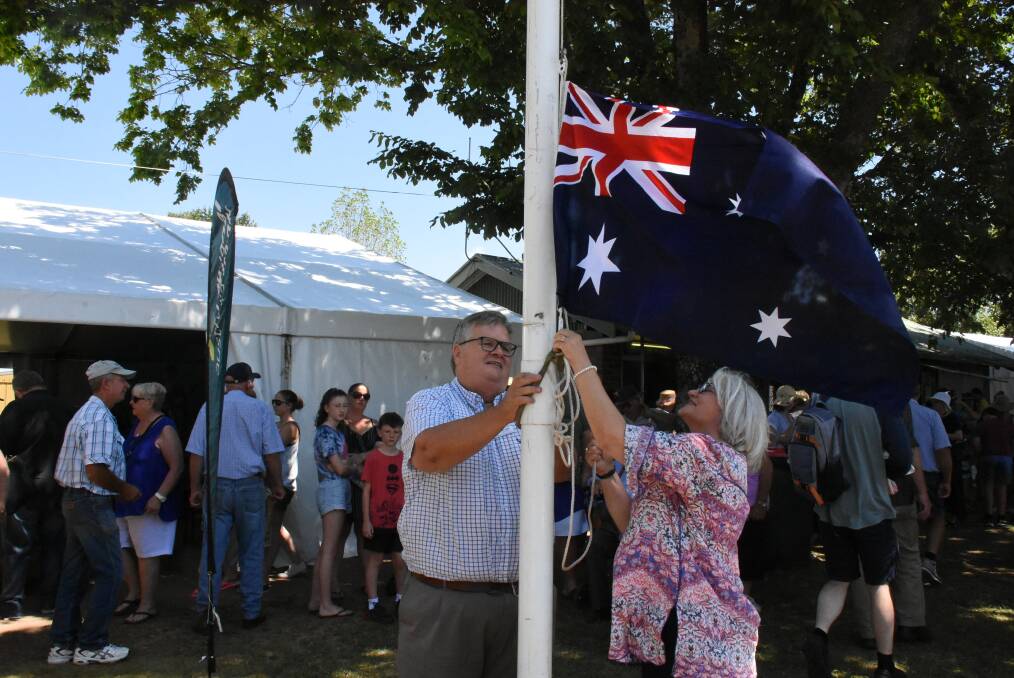 Aileen MacDonald and Cr Peter Bailey raise the flag in Rotary Park this morning. Photo: Nicholas Fuller