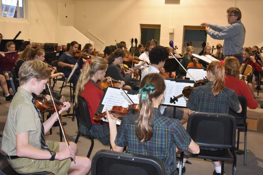 YOUNG MUSICIANS: Russell Bauer rehearsing the Armidale Youth Orchestras. Photo: Nicholas Fuller