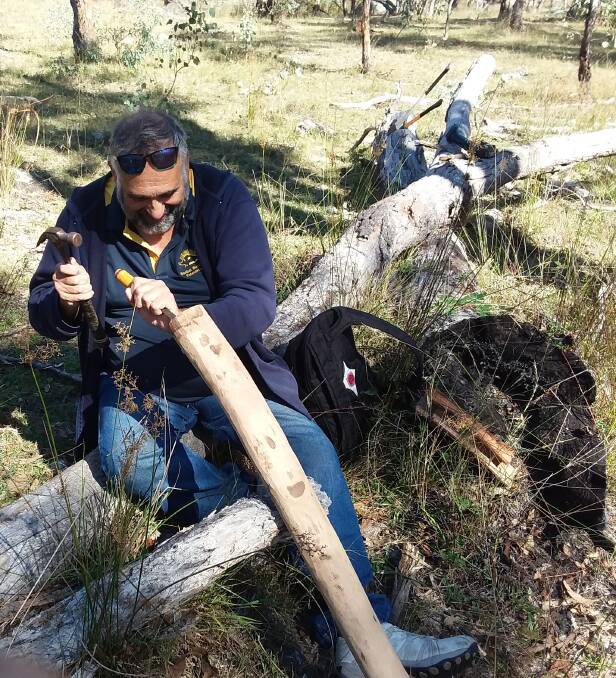 MUSIC MAN: Workshop participant Lee Patterson from Guyra hollows out a branch to make a Didgeridoo.