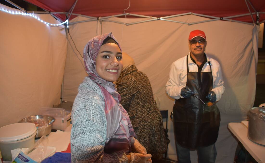 Mayam Algaleel, Maysoon Alruhaimi, and Hasan Algaleel, selling Iraqi food. Photo: Nicholas Fuller