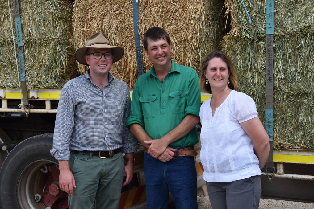 WELCOME RELIEF: Northern Tablelands MP Adam Marshall with farmers Matthew and Jenny Friend in front of the B-double fodder donation. Picture: Nicholas Fuller