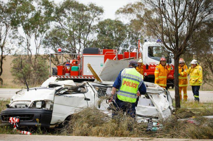 Emergency services personnel attend a crash scene on the Hume highway near Oolong where a female driver of a van died on Thursday morning after accidentally clipping a truck. Photo: Sitthixay Ditthavong