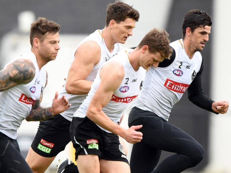 Scott Pendlebury (r) trains with his Magpies teammates on Thursday just days after finger surgery.