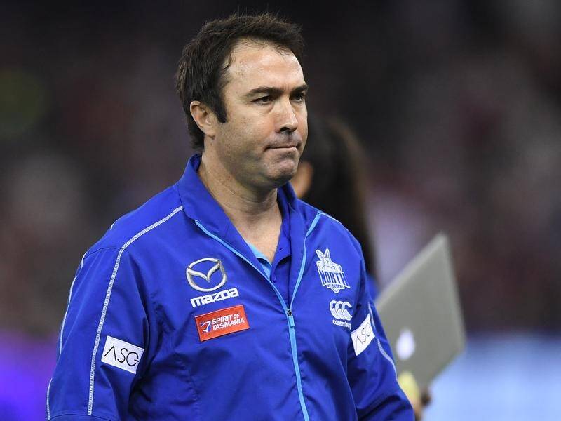 Coach Brad Scott is under fire after North Melbourne's disastrous 58-point AFL loss to Essendon.