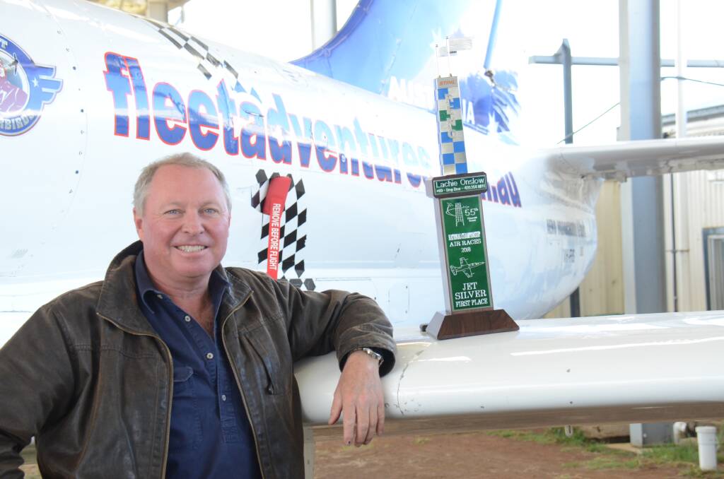 Lachie Onslow displays this year's Jet Silver trophy on the wing of the Fleet adventure jet at Armidale Airport.