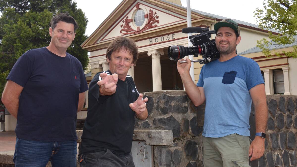 RECOGNITION: RJ Media film producer Chris Holding with new world record holder Anthony Kelly and camera operator Shane Hutt.