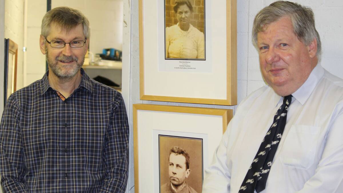 KEEPERS OF TIME: Archives officer Philip Ward and university archivist Bill Oates in front of the jail wall with photos of criminals Rose Brennan and Franck Wilson.